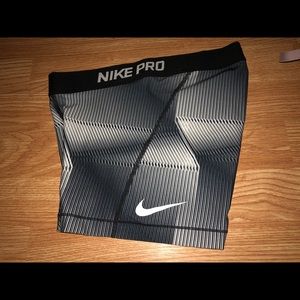 Grey and white Nike pros